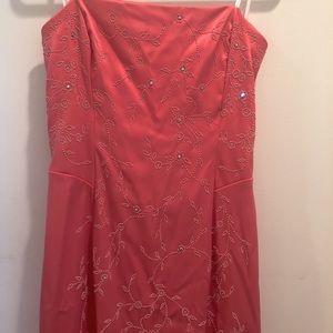 This dress is coral colored & has a small train.